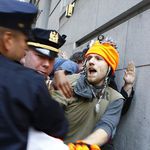 A protester gets arrested for "jumping" the barricade.